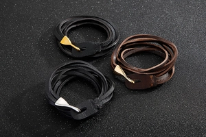 Detail showing braided leather bracelets in black and brown with fish hook metal clasps