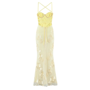 Detail of yellow evening gown featuring lace embroidery and lace-up back design