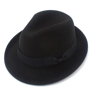 Close-up of black wool felt fedora featuring a classic ribbon band and side bow detail