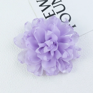 Detail of multi-layered lavender fabric chrysanthemum with delicate curled petal edges