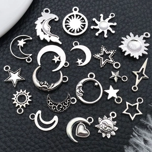 Set of vintage celestial charms featuring sun moon and stars on black leather background