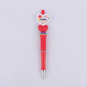 Detail of red beaded pen with teacher-themed heart topper and educational icons