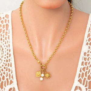 18k gold plated rolo chain necklace with heart, pearl and sun charms on a model