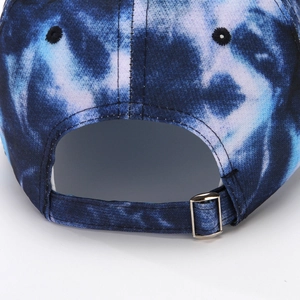 Detailed macro view of the blue tie-dye fabric texture and adjustable silver metal buckle