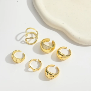 Set of six gold adjustable open rings featuring wave patterns and sparkling zircon details