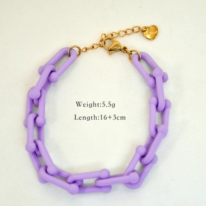 Detail of purple matte chain links with gold lobster clasp and heart steel pendant