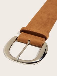 Detailed close-up of brown suede belt with polished silver U-shape buckle and matte finish