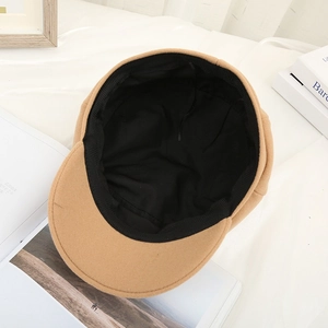 Detail view of camel wool newsboy hat brim and black inner lining construction