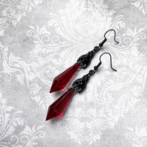 Gothic black bat earrings with red teardrop crystals on damask pattern background