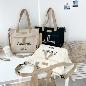 Detailed lifestyle shot of high-capacity canvas tote bags in beige, black, and off-white