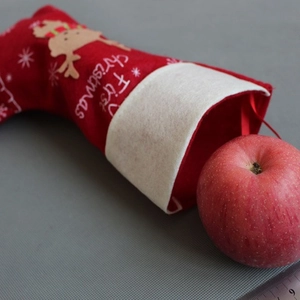 Red felt Christmas stocking with reindeer design and My First Christmas text for fireplace