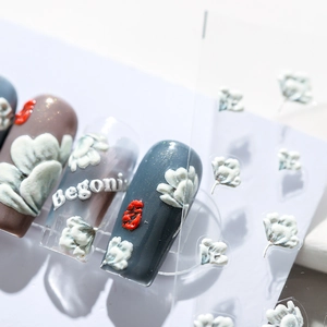3D embossed nail stickers featuring grey floral motifs and Begonia lettering design