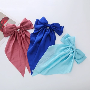 Three elegant satin oversized bow hair clips in pink, royal blue, and sky blue colors