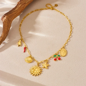 Gold stainless steel necklace with sun, chili, and starfish charms on a textured background
