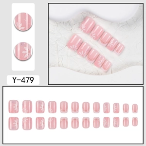 Short square pink press-on nails with white cherry blossom patterns and gold glitter accents