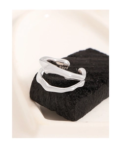 Macro detail of S925 sterling silver double-layered irregular wave ring on dark base