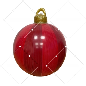 Detail of red inflatable Christmas ball featuring vertical stripes and gold hanging cap