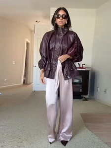 Detail of burgundy purple faux leather jacket with high collar and drawstring waist