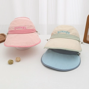 Detailed view of colorful summer sun visors with embroidered lettering and adjustable toggle