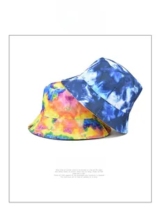 Detail shot of colorful tie-dye bucket hats in blue-white and rainbow canvas fabrics
