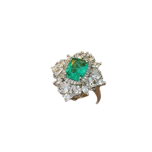 Elegant gold plated ring with emerald green stone and sparkling zircon halo design