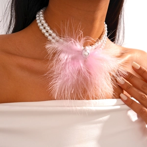 Detail of baroque pearl necklace featuring pink feather fringe and large pearl pendant