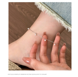 Dettaglio della cavigliera minimalista in argento sterling 925 con delicate perle bianche