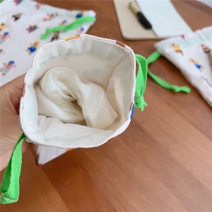 Close-up of drawstring cotton bag showing interior capacity with soft lining and bear print