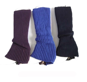 Detailed view of knitted leg warmers with bottom zipper in purple, blue, and black colors