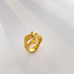 Macro shot of 18K gold plated ring with sculptural lava-inspired fluid design