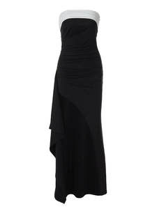 Detail of elegant black and white off-shoulder evening dress with ruffled slit skirt