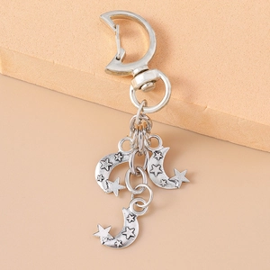 Vintage silver metal keychain with crescent moon clasps and star-patterned moon pendants