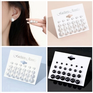 Detail of 12-pair pearl earring set in black and white sizes on display cards