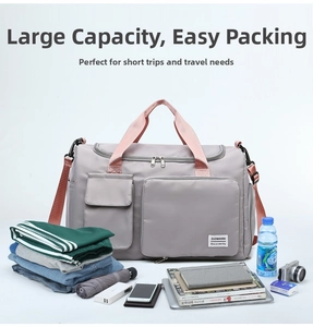 Detailed view of grey gym bag with multiple compartments and pink straps for travel