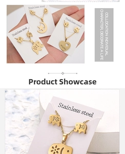 Detail of stainless steel necklace and earring set with heart and elephant patterns