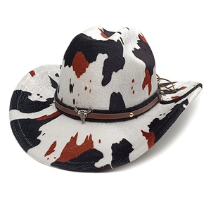 Western cow print cowboy hat with brown leather band and silver bull skull ornament