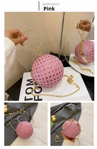 Detail of pink rhinestone spherical evening bag with golden circular handle and chain