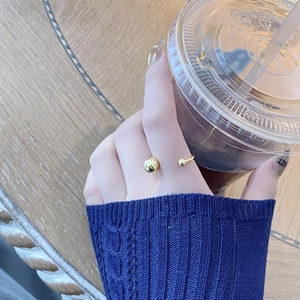 S925 sterling silver open ring with gold beads on model finger in lifestyle setting