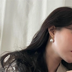 Elegant 925 sterling silver pearl drop earrings worn by a model in soft lighting
