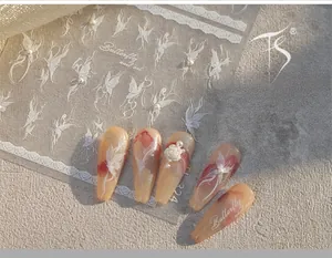 Detail of TL-324 butterfly nail art stickers with 3D pearls on reddish-brown nails