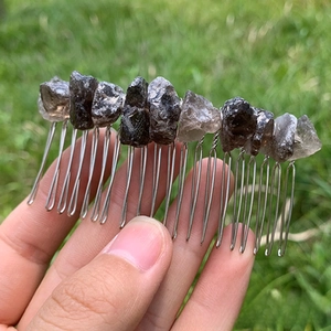 Close-up of handmade irregular smokey crystal stones wired to a 20-tooth silver hair comb