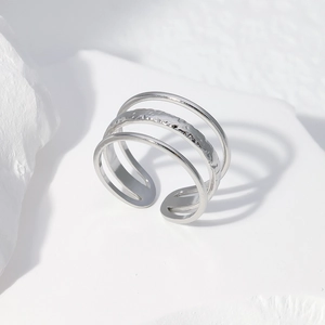 Detailed view of silver minimalist triple-layered steel ring with hammered texture