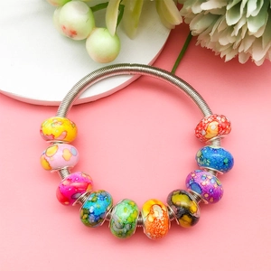 Detailed macro view of ink-painted resin beads with silver large-hole metal spring ring