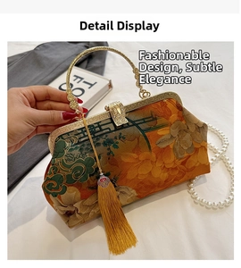 Detail of vintage Chinese floral handbag with gold metal handle and long yellow tassel decor