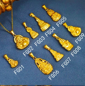 Detailed array of 24K gold plated Buddha and Guanyin pendants on textured blue surface