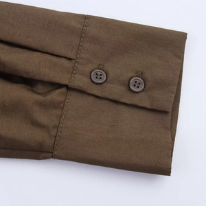Close-up of a dark brown poplin shirt dress cuff featuring a clean double-button design