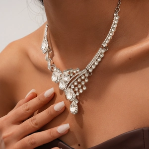Close-up of elegant silver teardrop necklace set with crystal rhinestones on model