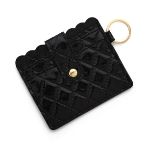 Detail of glossy black quilted card holder with wave edge and gold keyring