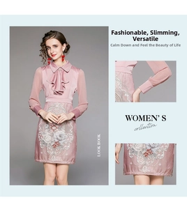 Detail of pink long sleeve dress with ruffle collar pearl button and floral embroidery