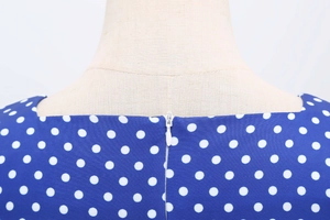 Detail shot of the back neckline and hidden zipper on the blue polka dot dress